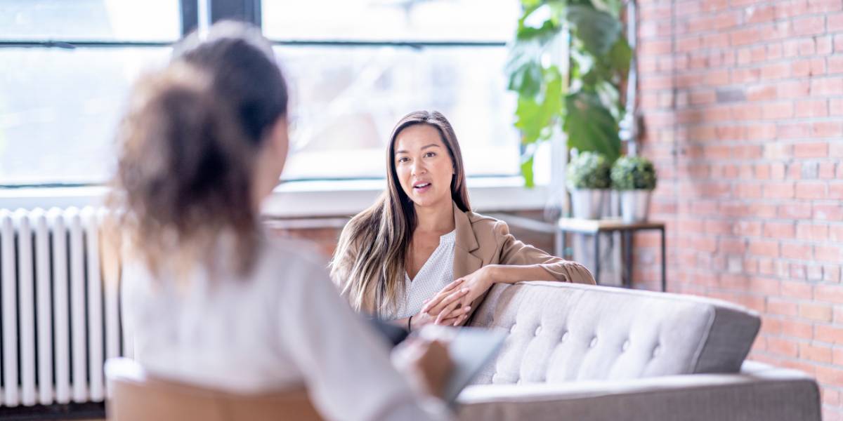 A therapist sitting with her client discussing sexual competence.